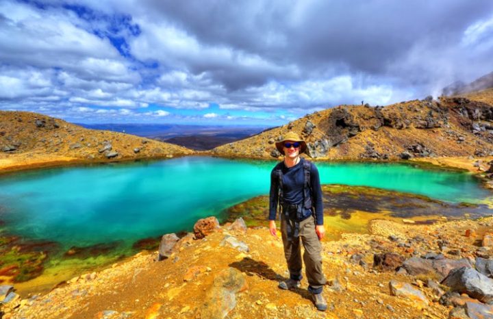 Standing by the blue crater lake on the Tongariro Crossing